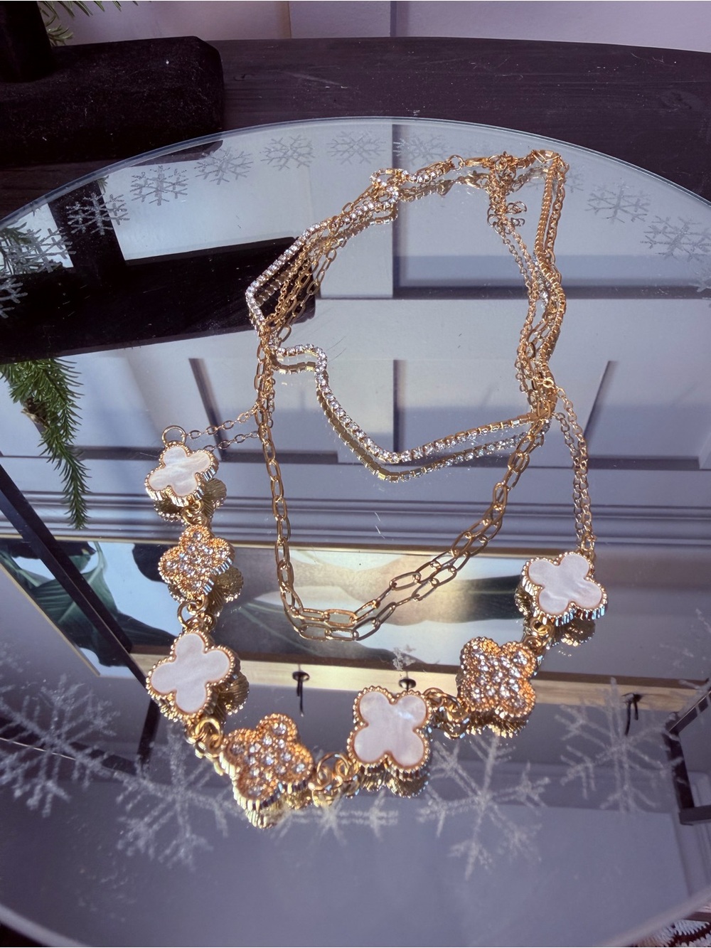 Gold tone floral necklace features clover-shaped motifs inlaid mother-of-pearl